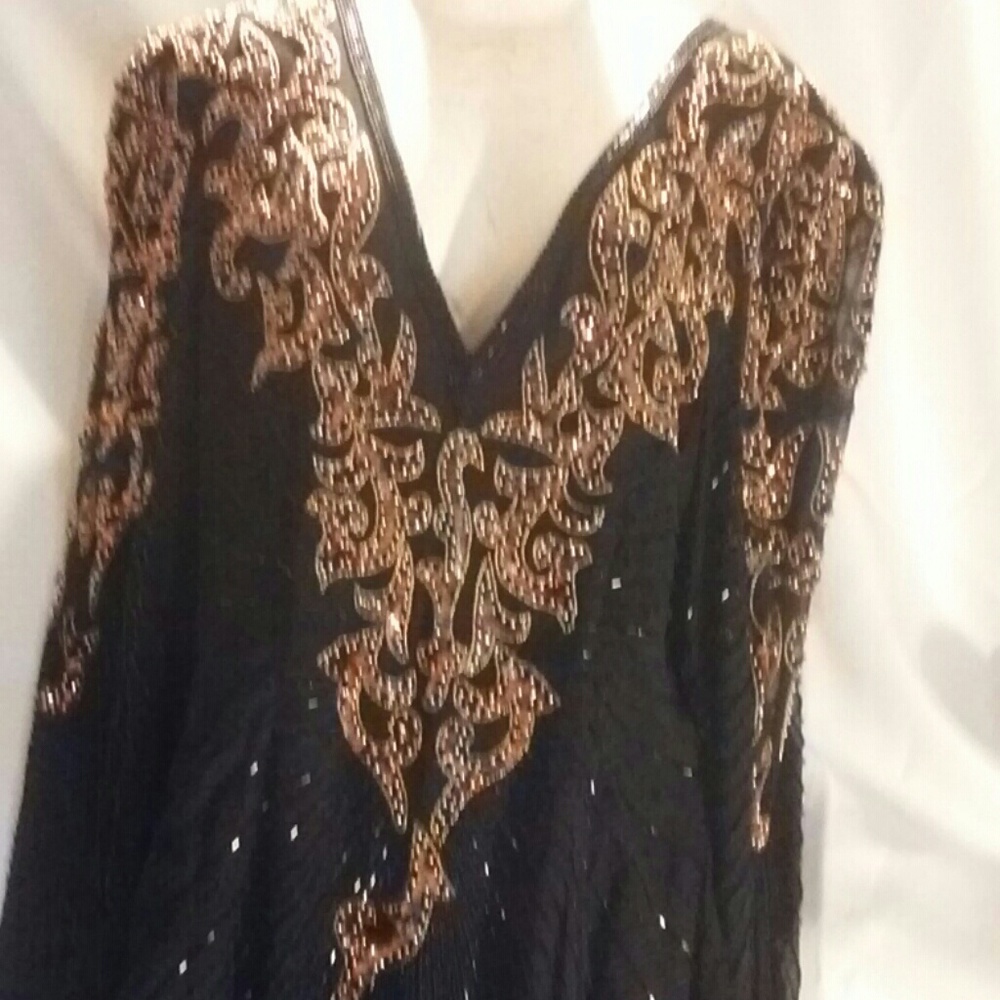 Ladies long sequin dress with beaded jewelry .